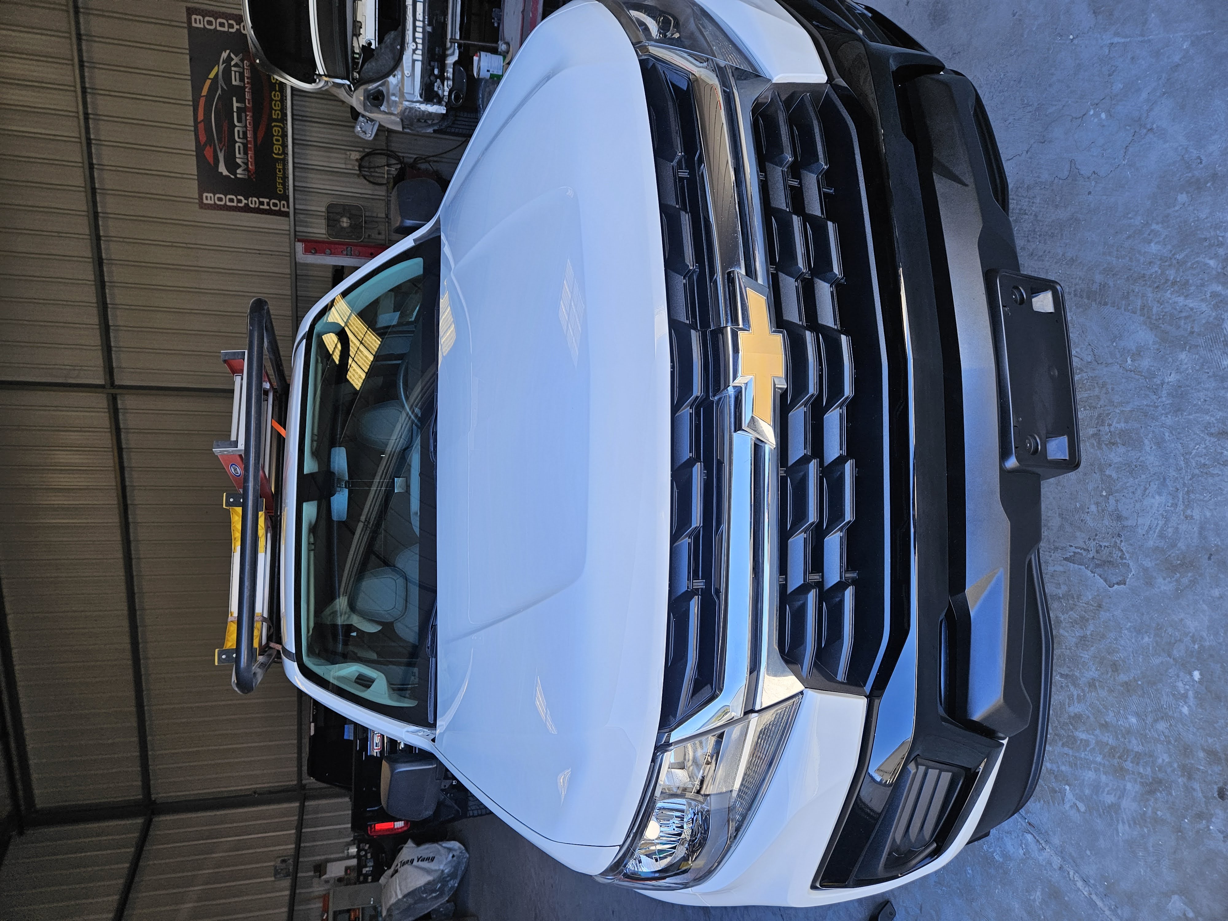 White truck restored after collision repair
